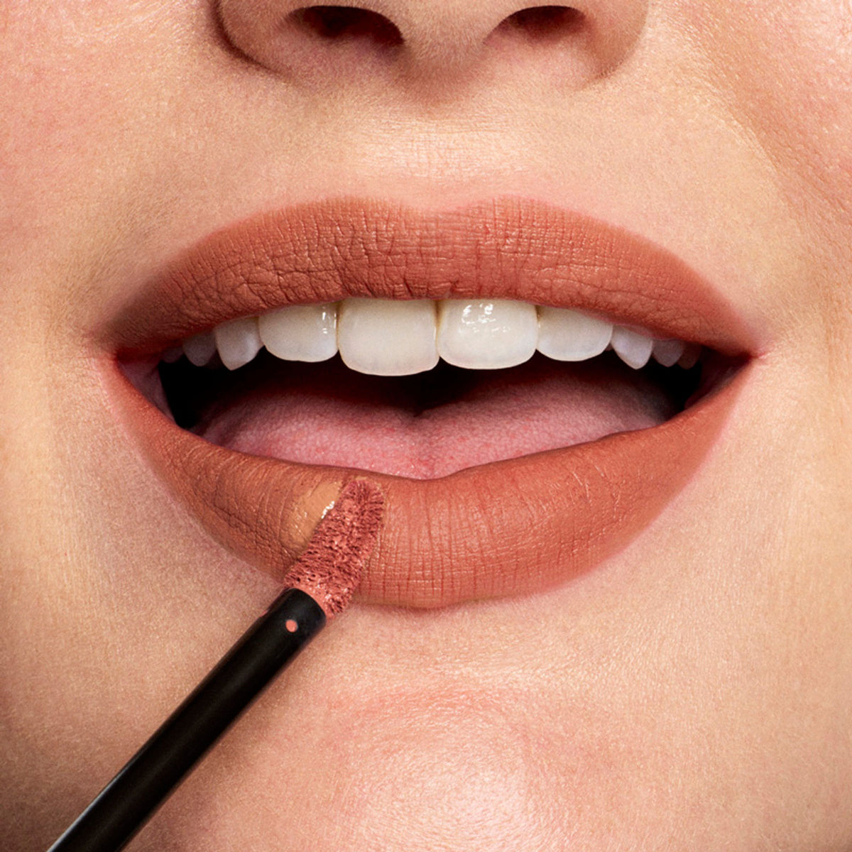 Stila Cosmetics Stay All Day Liquid Lipstick in Foxy, vibrant orange shade, displayed in tube with applicator.