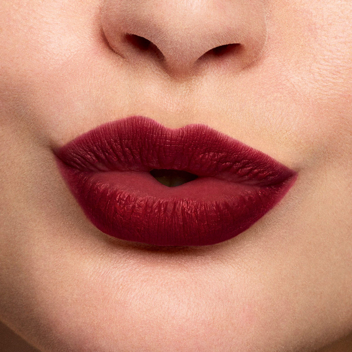 Stila Cosmetics Stay All Day Liquid Lipstick in Bordeaux with deep red matte finish and applicator brush visible in the image.
