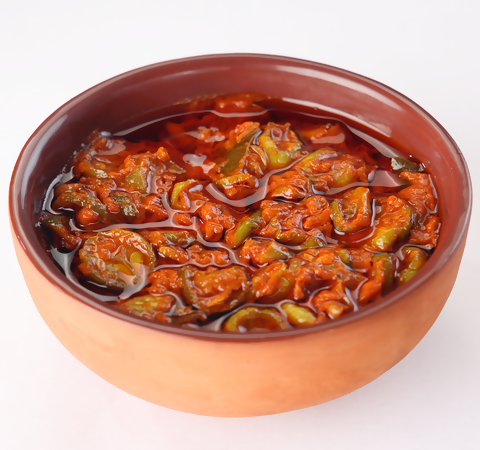 Glass jar of Godavari Vantillu Dondakaya pickle with sliced green vegetables, showcasing North Indian-style pickle in a clear container.