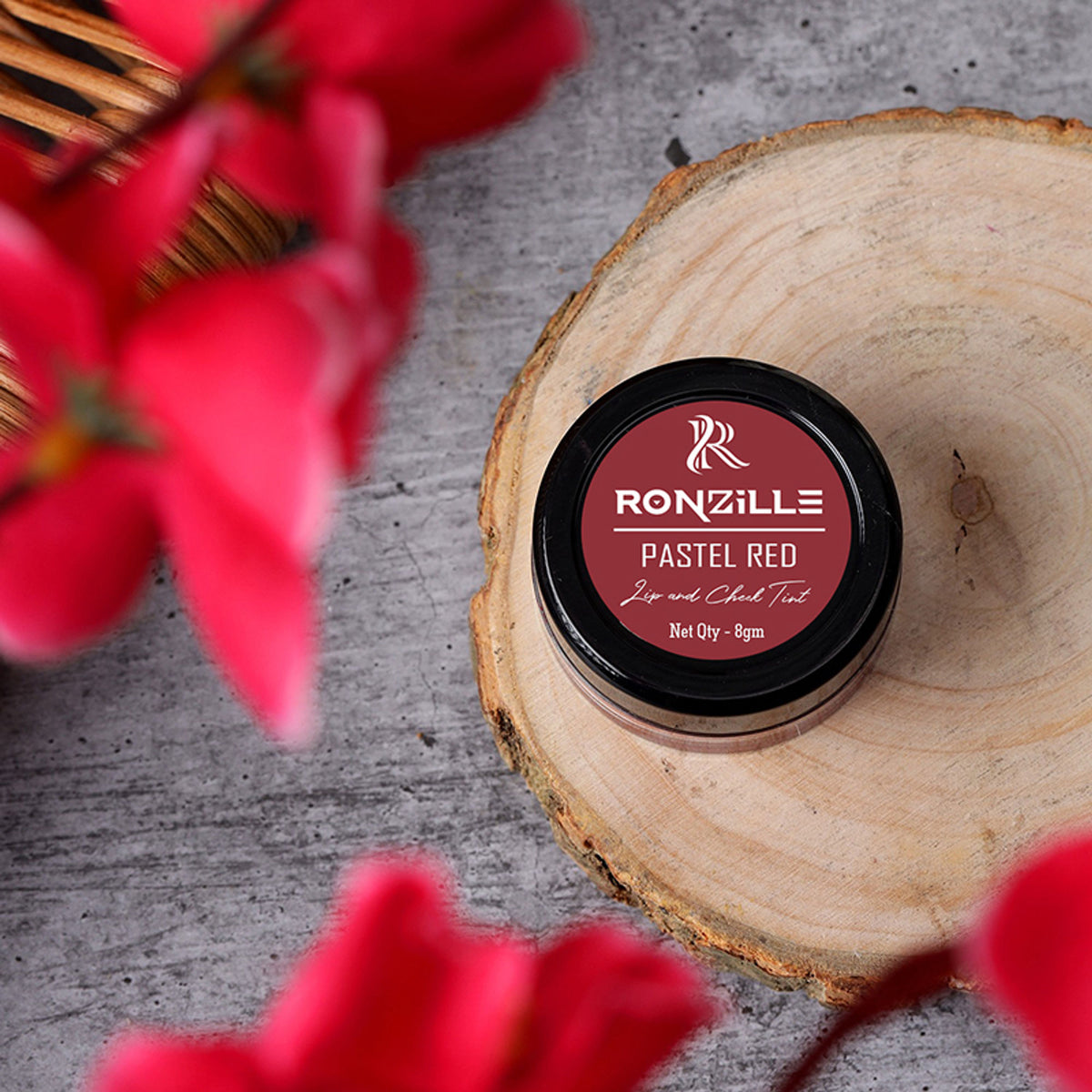 Ronzille Lip and Cheek Tint in Pastel Red, showcasing the sleek tube and vibrant color for natural lip and cheek makeup.