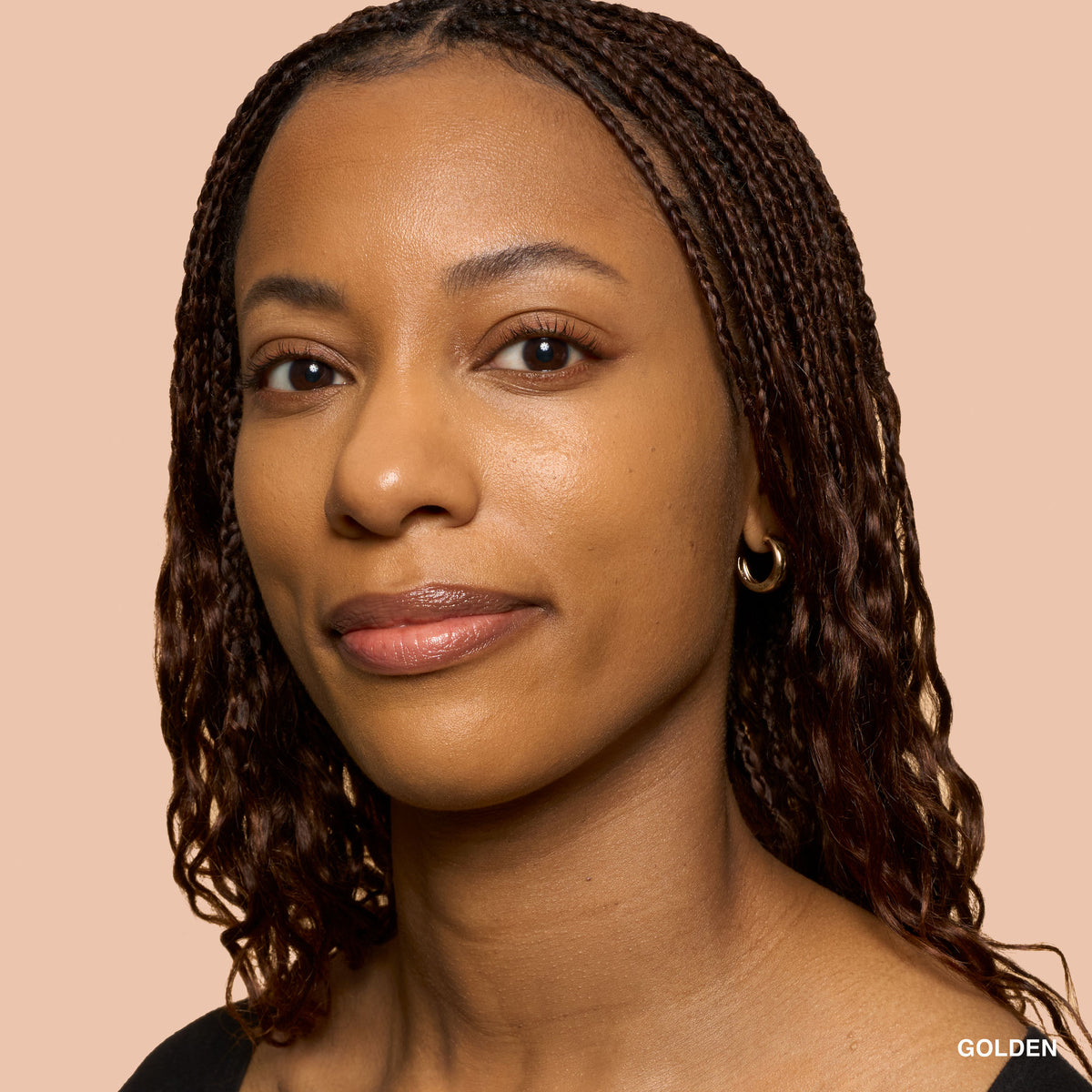 Bobbi Brown Weightless Skin foundation with SPF 15 in Golden shade, featuring natural matte finish, displayed in a sleek bottle.