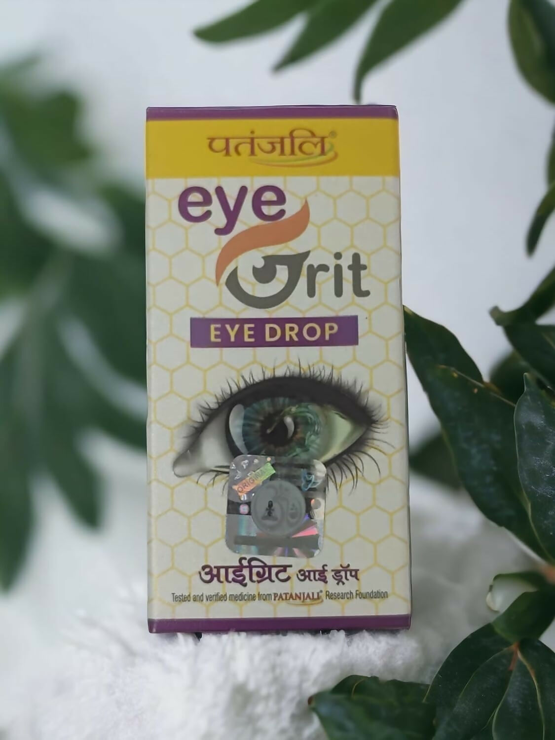 Patanjali Divya Eyegrit Ayurvedic eye drops in a white bottle with a green cap, designed for soothing and refreshing eyes.