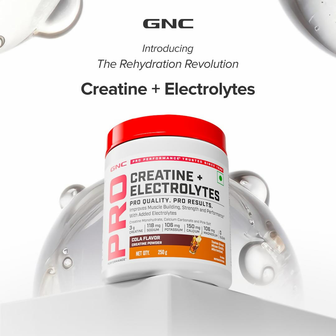 GNC Creatine+ Electrolytesh Cola Ayurvedic protein powder in a container with scoop and label showing cola flavor and nutritional info.