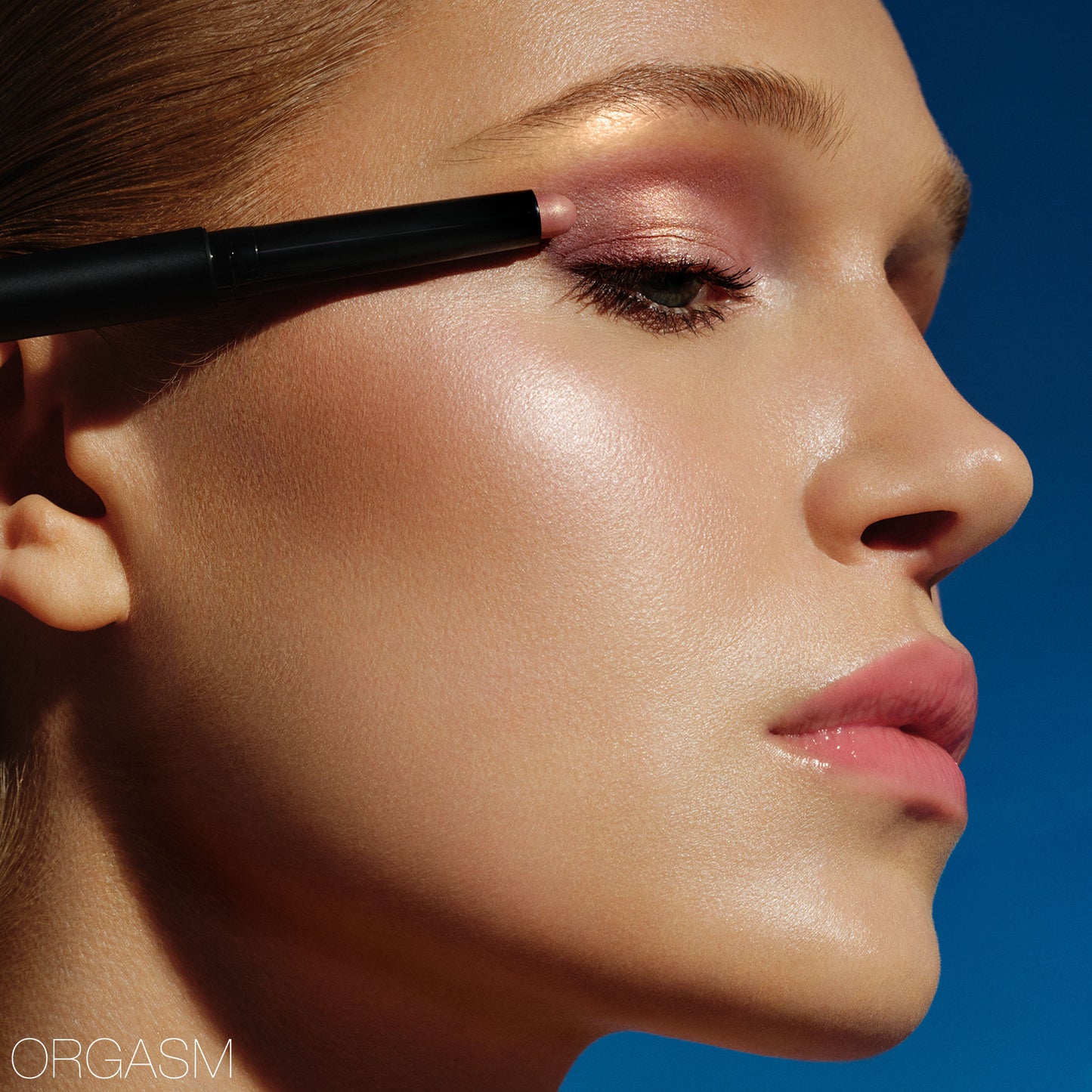 NARS Total Seduction Eyeshadow Stick Ablaze in gold and bronze shades, rolled-up with smooth, shimmery texture visible.