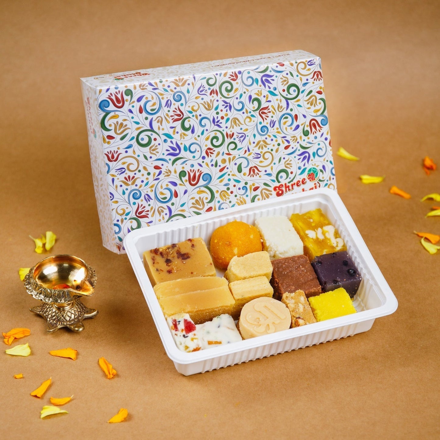 Assorted North Indian sweets from Shree Mithai in vibrant indigo packaging, featuring traditional Indian desserts.
