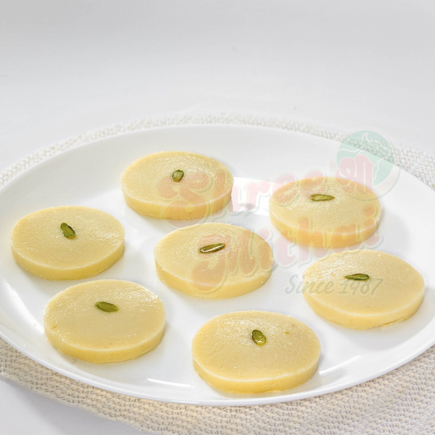 Shree Mithai White Peda, North Indian sweet with round, creamy white peda garnished with a small pistachio on top.