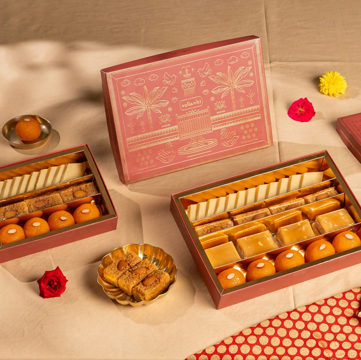 Assorted North Indian sweets box by Vellanki Foods with colorful traditional treats arranged in a decorative box.