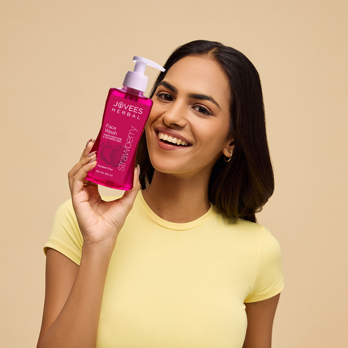 Jovees Herbal Strawberry Face Wash in a clear bottle with a pink cap, featuring a strawberry image and herbal ingredients.