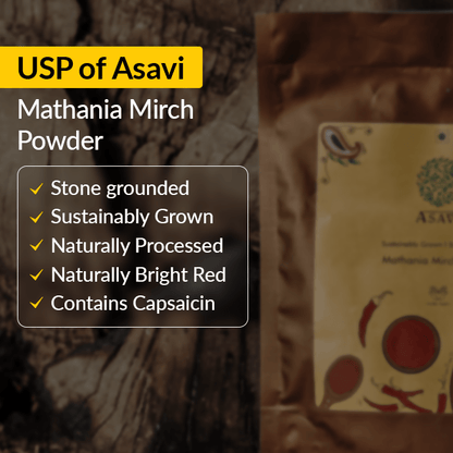 Asavi Stone Grounded Mathania Chilli Powder in a glass jar, vibrant red chili flakes with a textured, ground appearance.