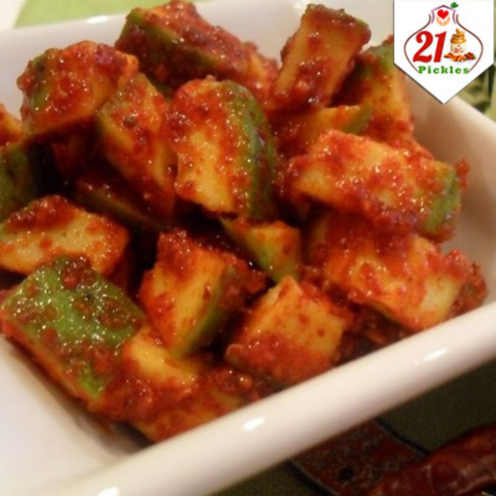 Jar of 21Pickles Mango Pickle, North Indian style, with vibrant mango pieces and spices in a glass container.