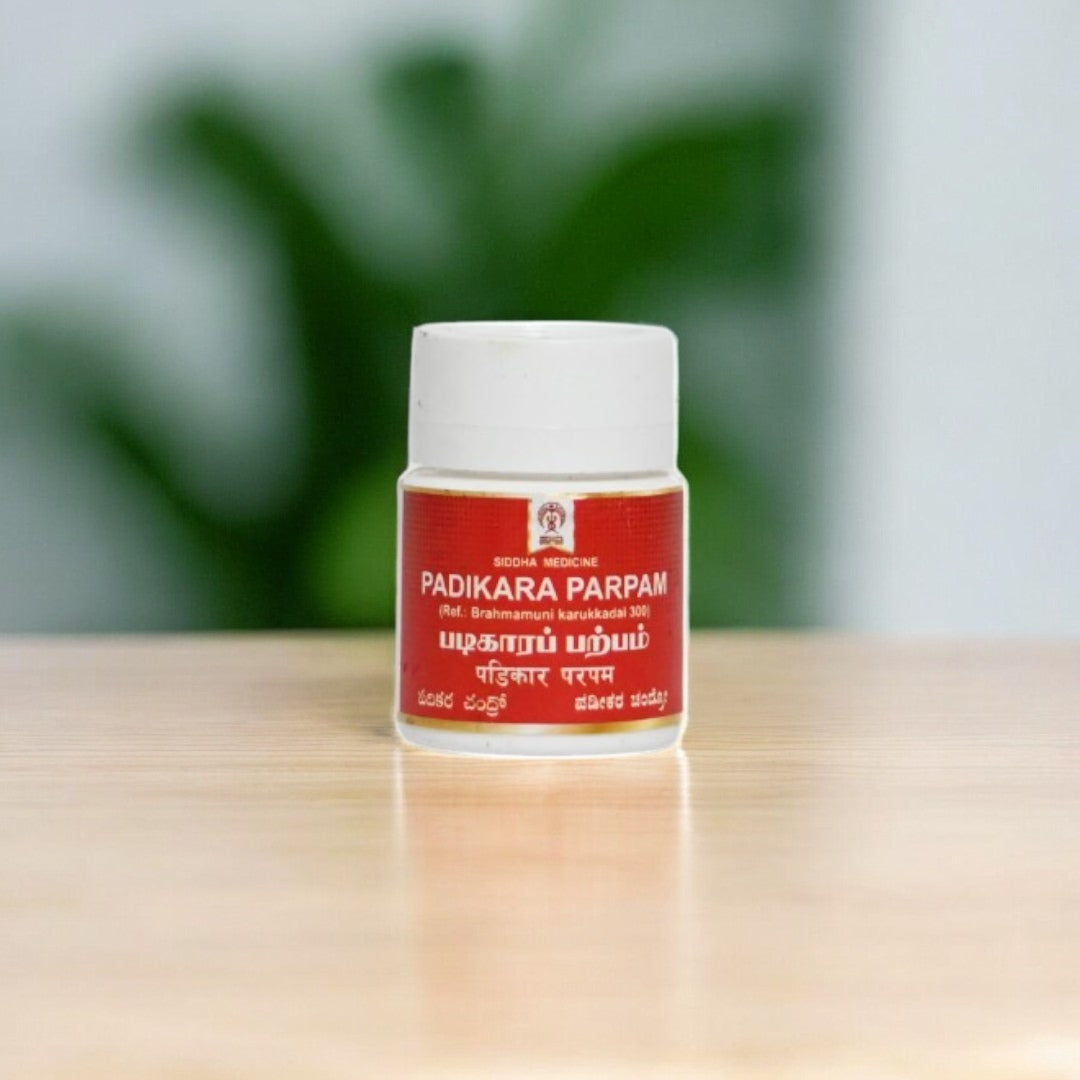 Impcops Padikara Parpam Ayurvedic herbal powder in a glass jar with a spoon, traditional Indian medicinal product for health.