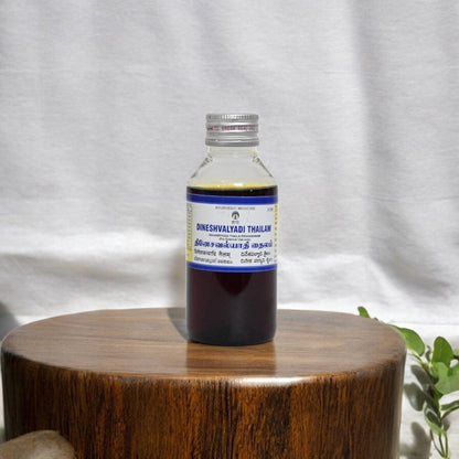 ImpCops Dineshavalyadi Ayurvedic Thailam in a glass bottle with dropper, traditional herbal medicinal oil for wellness.