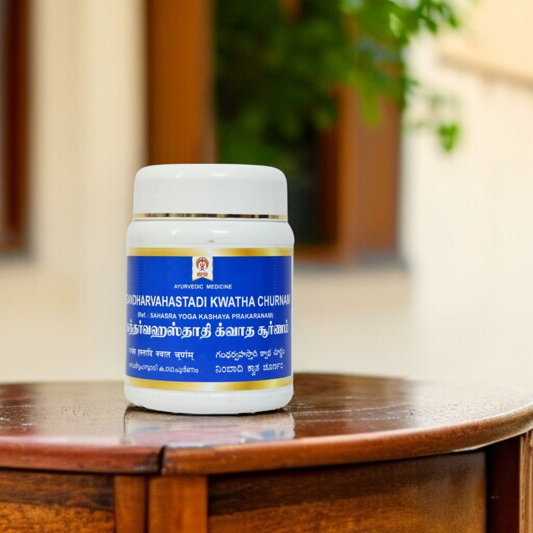 Impcops Gandharva Hastadi Kwatha Churnam Ayurvedic powder in a glass jar with a wooden spoon, traditional herbal churna for health.