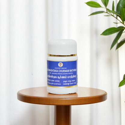 Impcops Dadimashtaka Churnam Ayurvedic tablets in a glass bowl, showcasing herbal powder with traditional packaging behind.