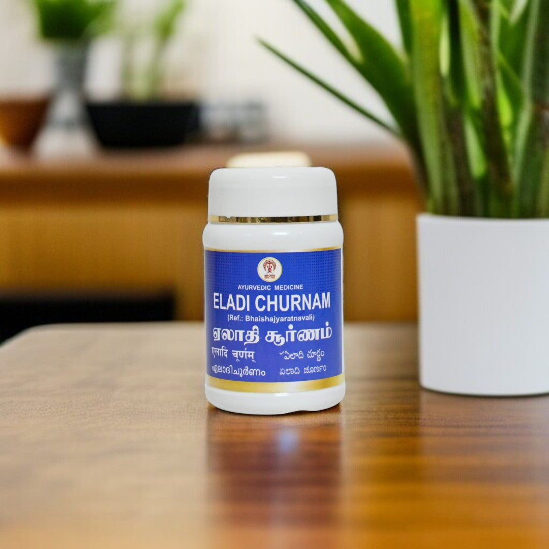 Impcops Eladi Churnam Ayurvedic powder in a glass jar with dried cardamom pods, traditional herbal remedy for digestion.