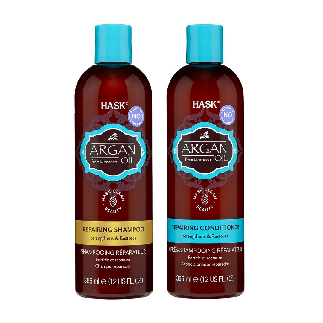 HASK Repairing Argan Oil shampoo and conditioner set with bottles showing on a bathroom shelf, highlighting nourishing hair care.