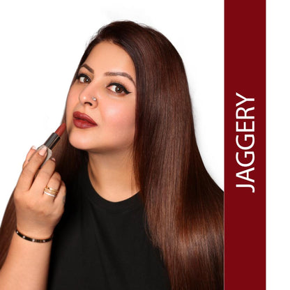 Love Earth satin matte lipstick in Jaggery shade, showing a close-up of the lipstick tube with the product name and brand.