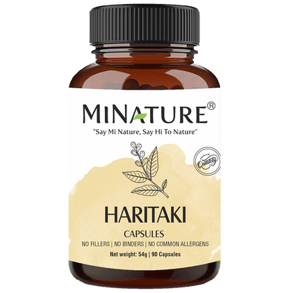 Tiny Minature brand Ayurvedic Haritaki capsules in a clear container, showcasing small, natural herbal supplement capsules.