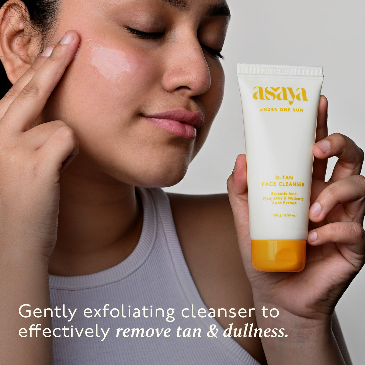 Asaya De Tan Skin Brightening Face Wash with Manjistha and Glycolic Acid for instant tan removal, shown in a clear bottle.