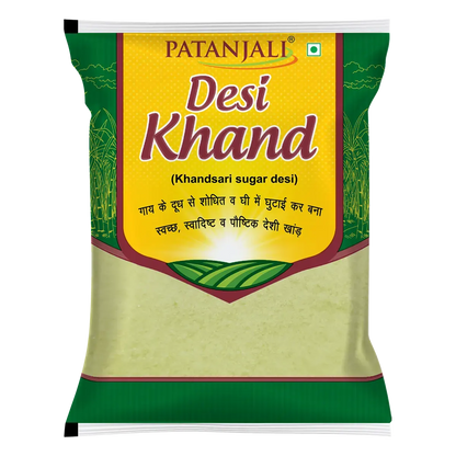 Patanjali Desi Khand natural sugar in a clear container, showcasing golden, crystalline granules for traditional sweetening.