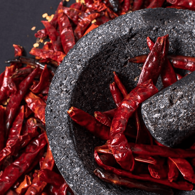 Asavi Stone Grounded Mathania Chilli Powder in a jar, vibrant red chili powder with a rich, spicy appearance.