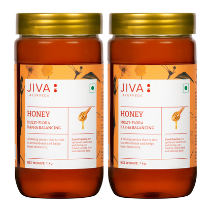 Jiva Ayurveda honey jar, natural and pure honey spread, with a golden color and label, in a glass jar.