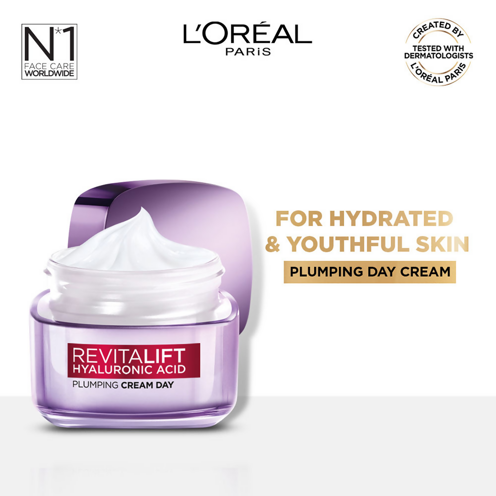 L'Oreal Paris Hydrated, plump, and radiant skin serum and essence kit with skincare bottles and applicators on a white background.