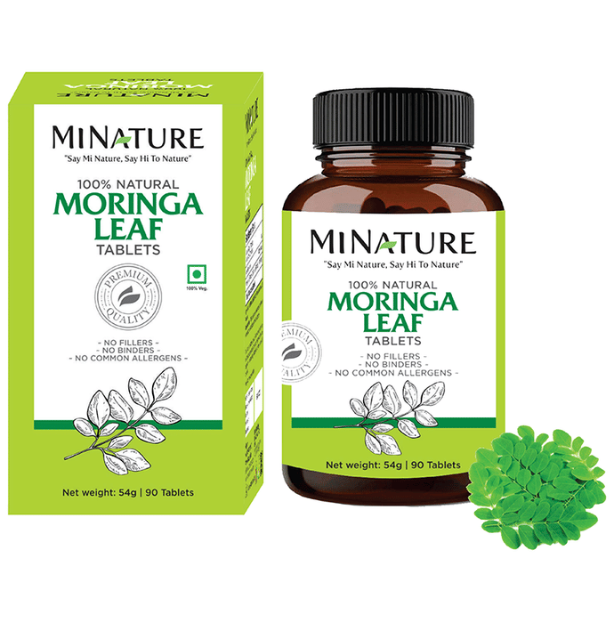 Miniature Ayurvedic Moringa leaf tablets, 100% natural, shown in blister pack with green Moringa leaves on packaging.