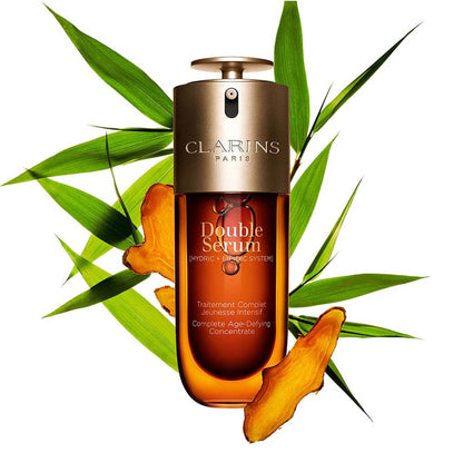 Clarins Double Serum in a clear glass bottle with a pump dispenser, showing the iconic dual-chamber design.