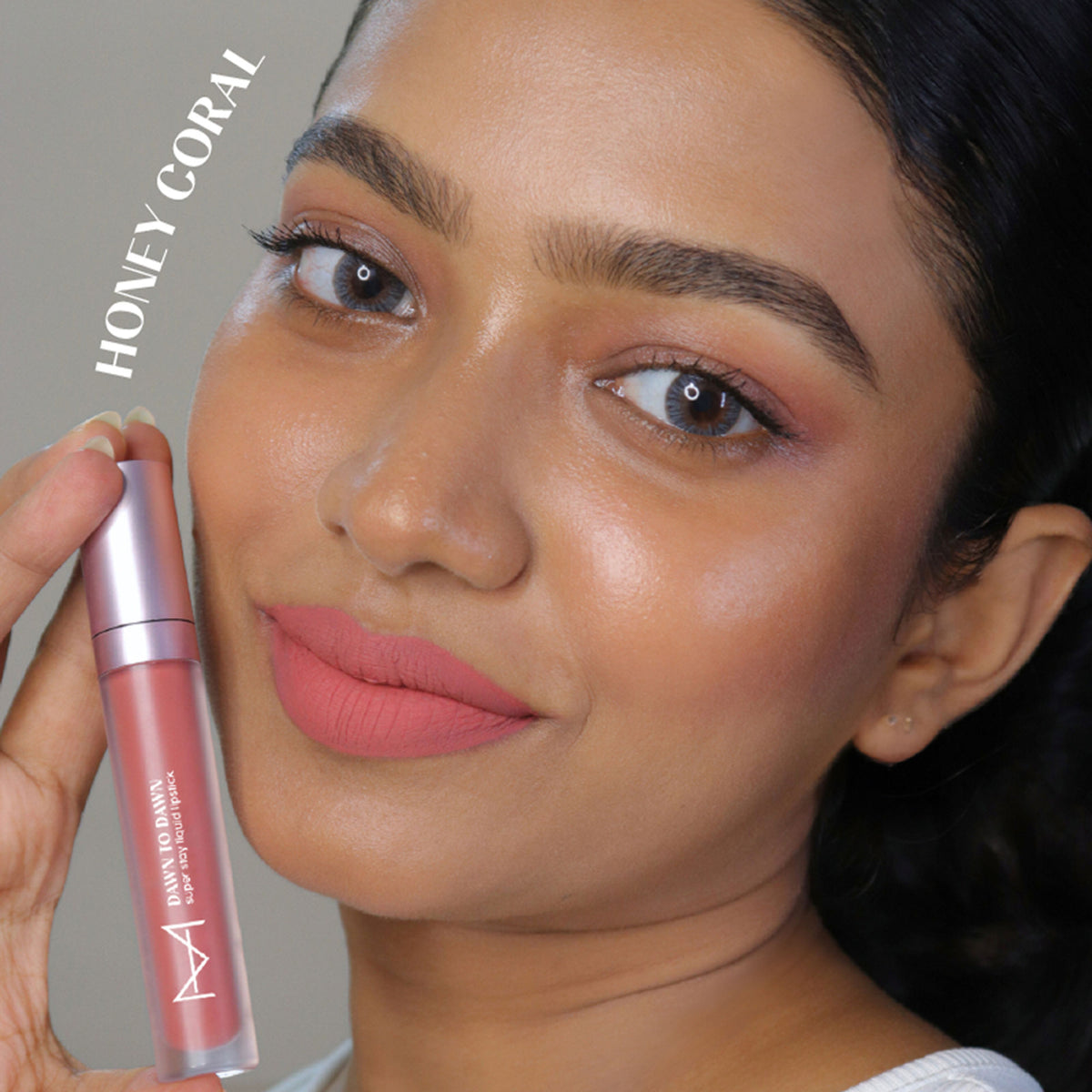 House of Makeup Dawn To Dawn liquid lipstick in Honey Coral, showing the vibrant coral shade in a sleek tube.