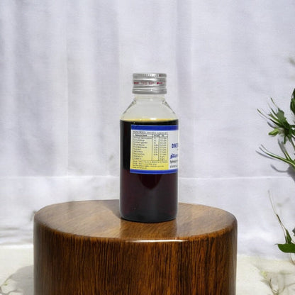 Impcops Dineshavalyadi Thailam Ayurvedic oil in a glass bottle with dropper, used for traditional herbal skincare and wellness.