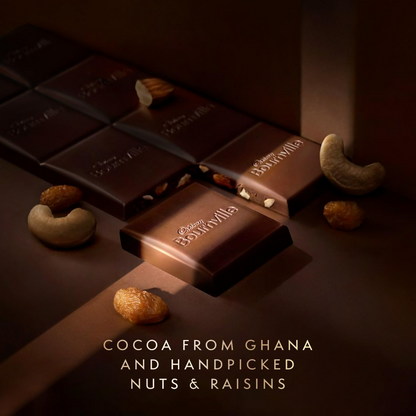Cadbury Bournville dark chocolate bar with visible pieces of fruit and nuts in a sleek packaging.