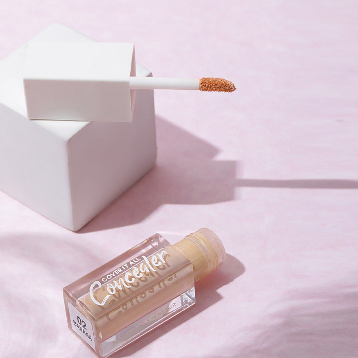 CUFFS N LASHES Cover It All Liquid Concealer in shade 02 Banana, showing the sleek applicator and creamy consistency.