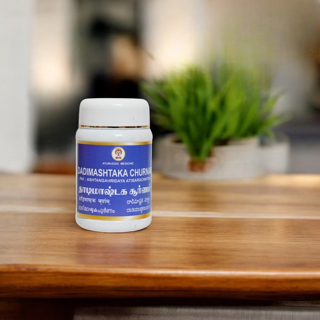 Impcops Dadimashtaka Churnam Ayurvedic herbal powder in a glass bowl with dried herbs and spices on a wooden surface.