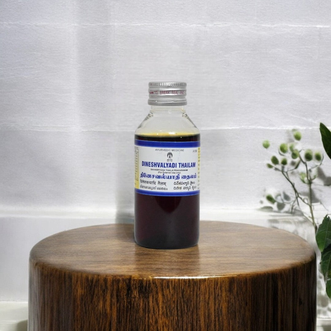 Impcops Dineshavalyadi Thailam Ayurvedic herbal oil in a glass bottle with dropper for traditional healing and skin care.