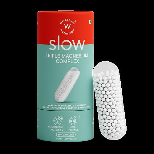 Wellbeing Nutrition Slow Triple Magnesium Complex Ayurvedic capsules in a bottle, with 30 capsules visible.