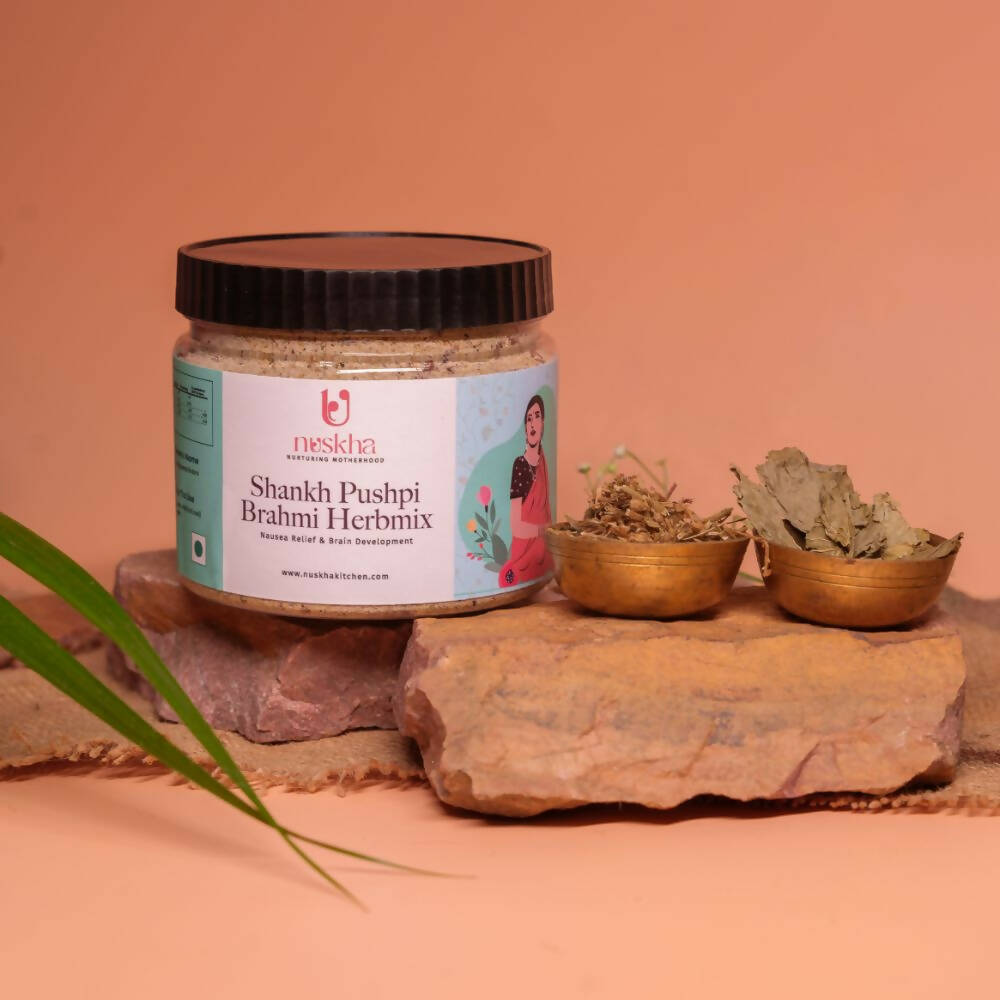 Nuskha ShankhPushpi Brahmi herbal health drink in a glass, showcasing the herbal blend with fresh herbs and ingredients.