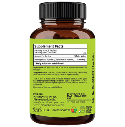 Minature Ayurvedic Moringa Leaf Tablets, 100% natural mini tablets, shown in blister pack with green Moringa leaves.