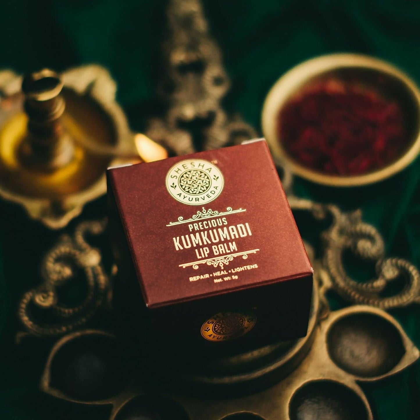 Shesha Ayurveda Kumkumadi Brightening Lip Balm tube showing the product with natural packaging and label on a white background.