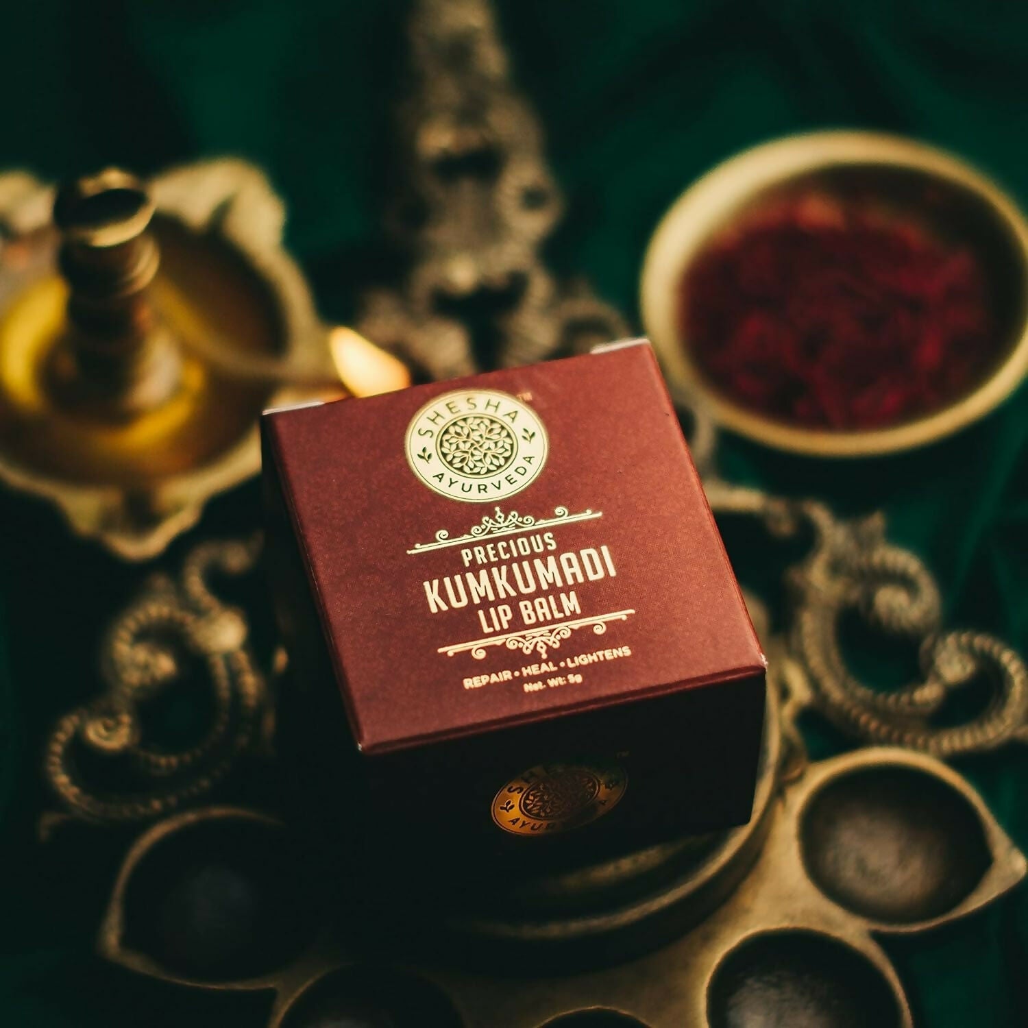 Shesha Ayurveda Kumkumadi Brightening Lip Balm tube showing the product with natural packaging and label on a white background.