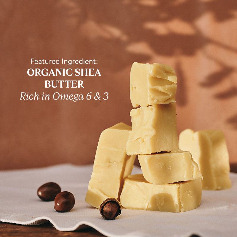 L'Occitane Shea Butter Fabulous Oil for face, showing a sleek glass bottle with a dropper, surrounded by shea nuts and plant extracts.