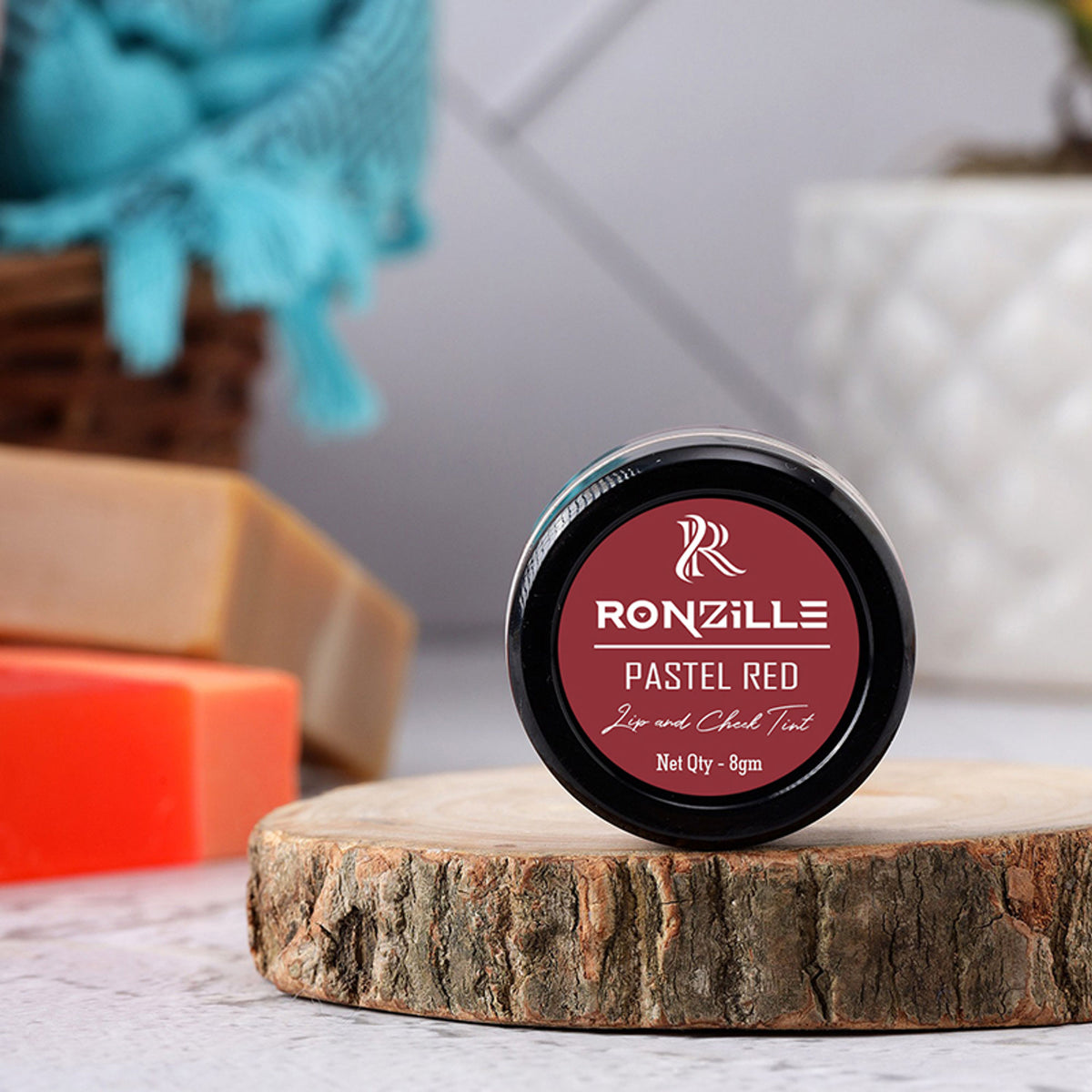Ronzille Lip and Cheek Tint in Pastel Red, showing the smooth, creamy texture and vibrant color on a makeup palette.