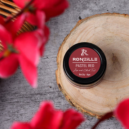 Ronzille Lip and Cheek Tint in Pastel Red, showcasing the sleek tube and vibrant color for natural lip and cheek makeup.