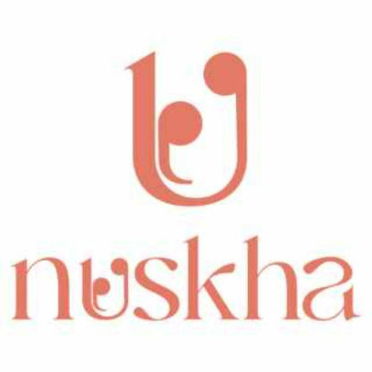 Nuskha ShankhPushpi Brahmi herbal health drink in a clear glass with fresh herbs and flowers, highlighting natural ingredients.