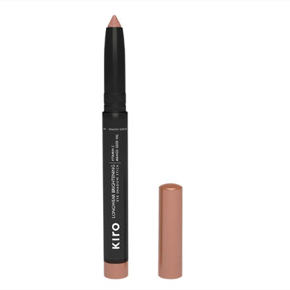 KIRO Long Wear Brightening Eye Shadow Stick in Peachy Gold, showing the creamy textured eyeshadow on a neutral background.
