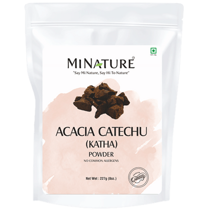 Minature Acacia Catechu (Katha) powder for hair masks, fine brown powder in a small container with a white background.