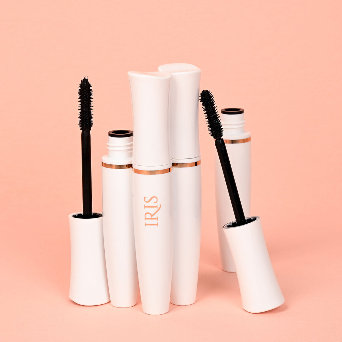 Close-up of IRIS COSMETICS All About That Drama Voluminous Mascara wand with black mascara applied to lashes.
