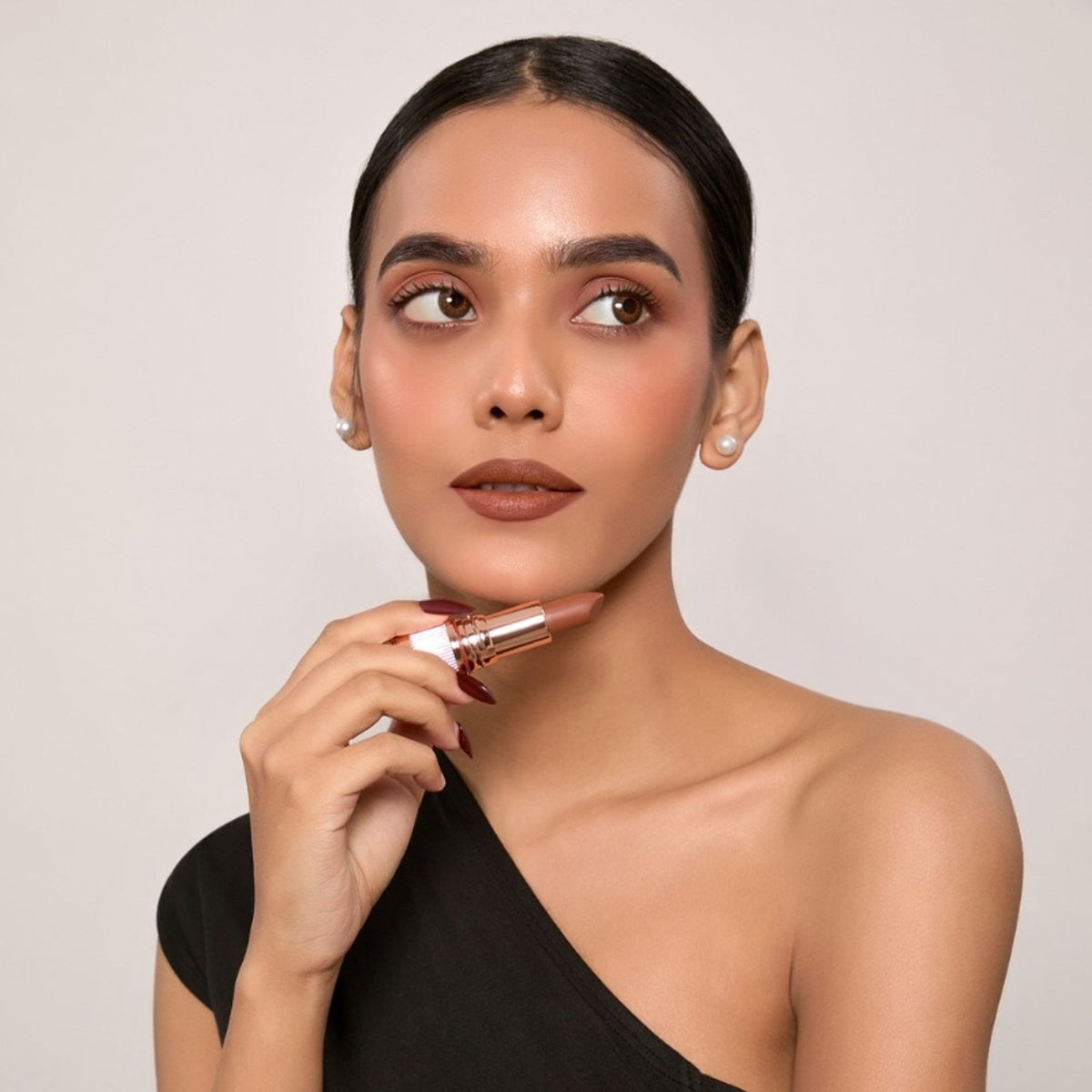 Europe Girl Silky Matte Lipstick in EG-17 Espresso, showing a close-up of the deep brown lipstick bullet on the tube.