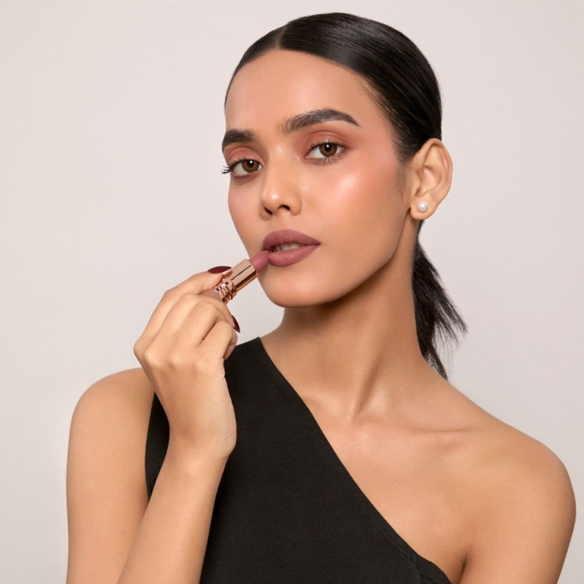 Europe Girl Silky Matte Lipstick in EG-12 Truffle, showcasing a smooth, rich lipstick bullet with a matte finish.