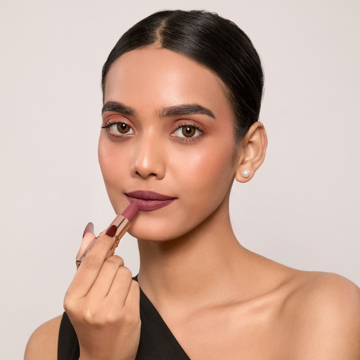 Europe Girl Spice Silky Matte Lipstick EG-10, showing a smooth, rich cinnamon-colored lipstick in a sleek tube.